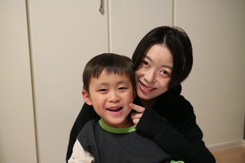 インタビューに答えてくれた松本さんとお子さんの写真。二人とも笑顔でカメラを見ている。