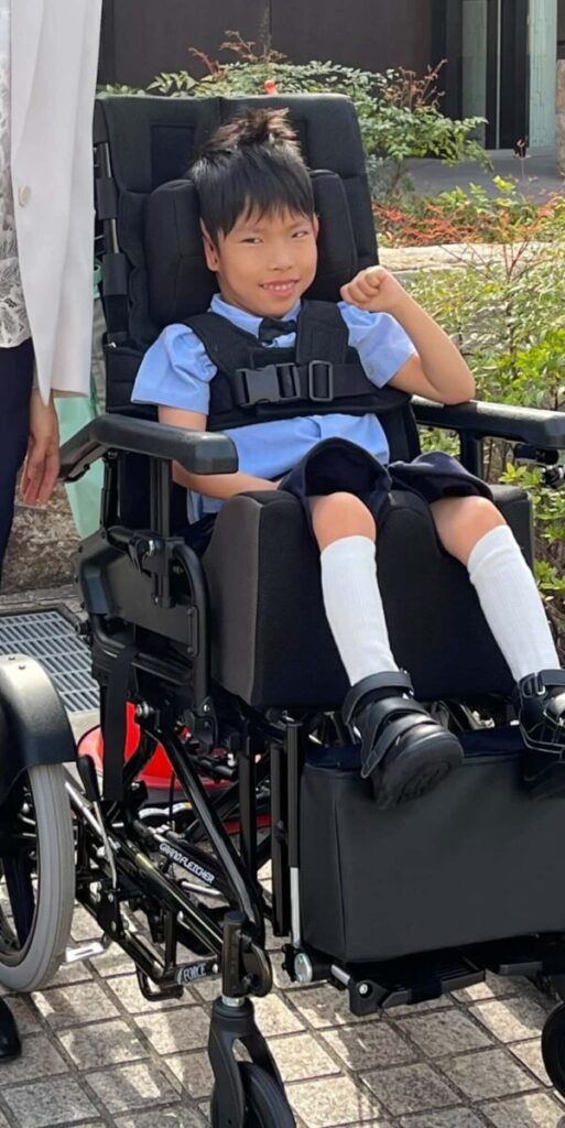 セレモニースーツを着て車椅子に乗っている男の子